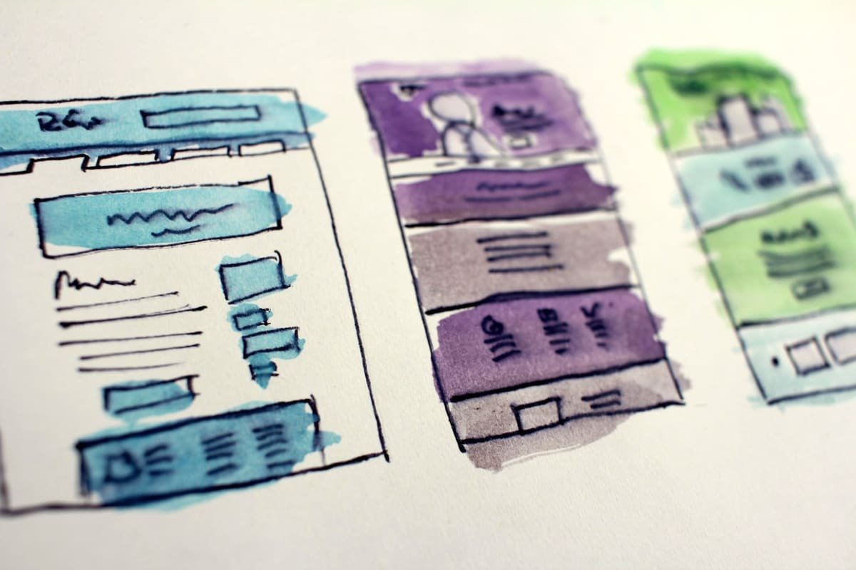 Hand-drawn watercolour wireframes of website pages